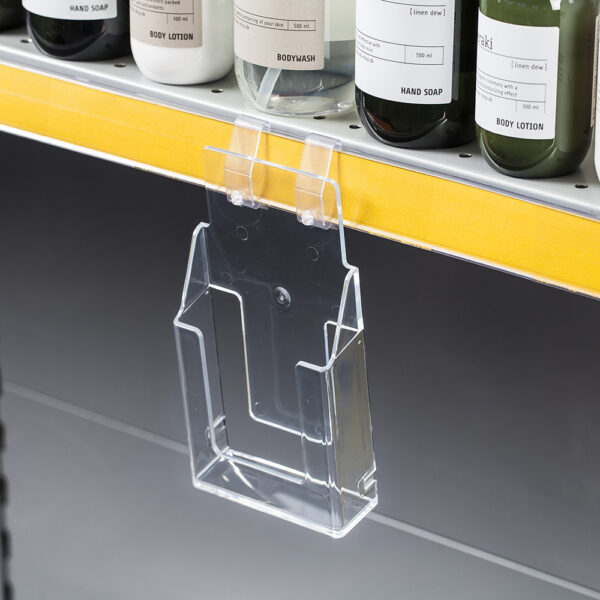 Flat Baked leaflet dispenser attached to the edge of a shelf, but can also be wall mounted to hold A4, A5 or a4 DL leaflets.