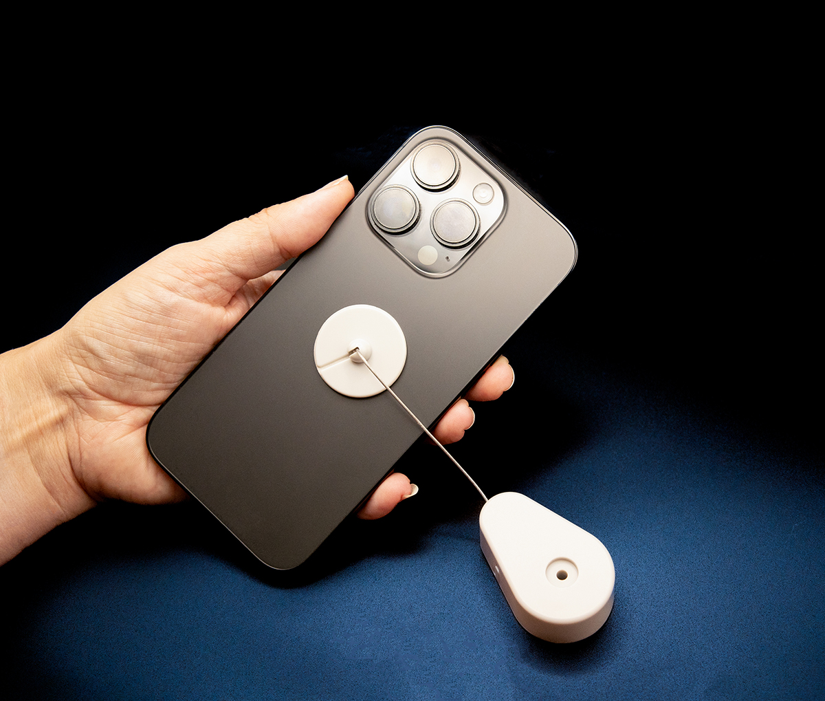 Retractable Security Tether with Adhesive Pad
