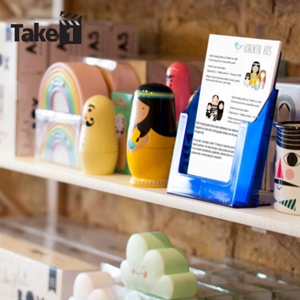 blue leaflet dispenser on a shelf in a retail shop